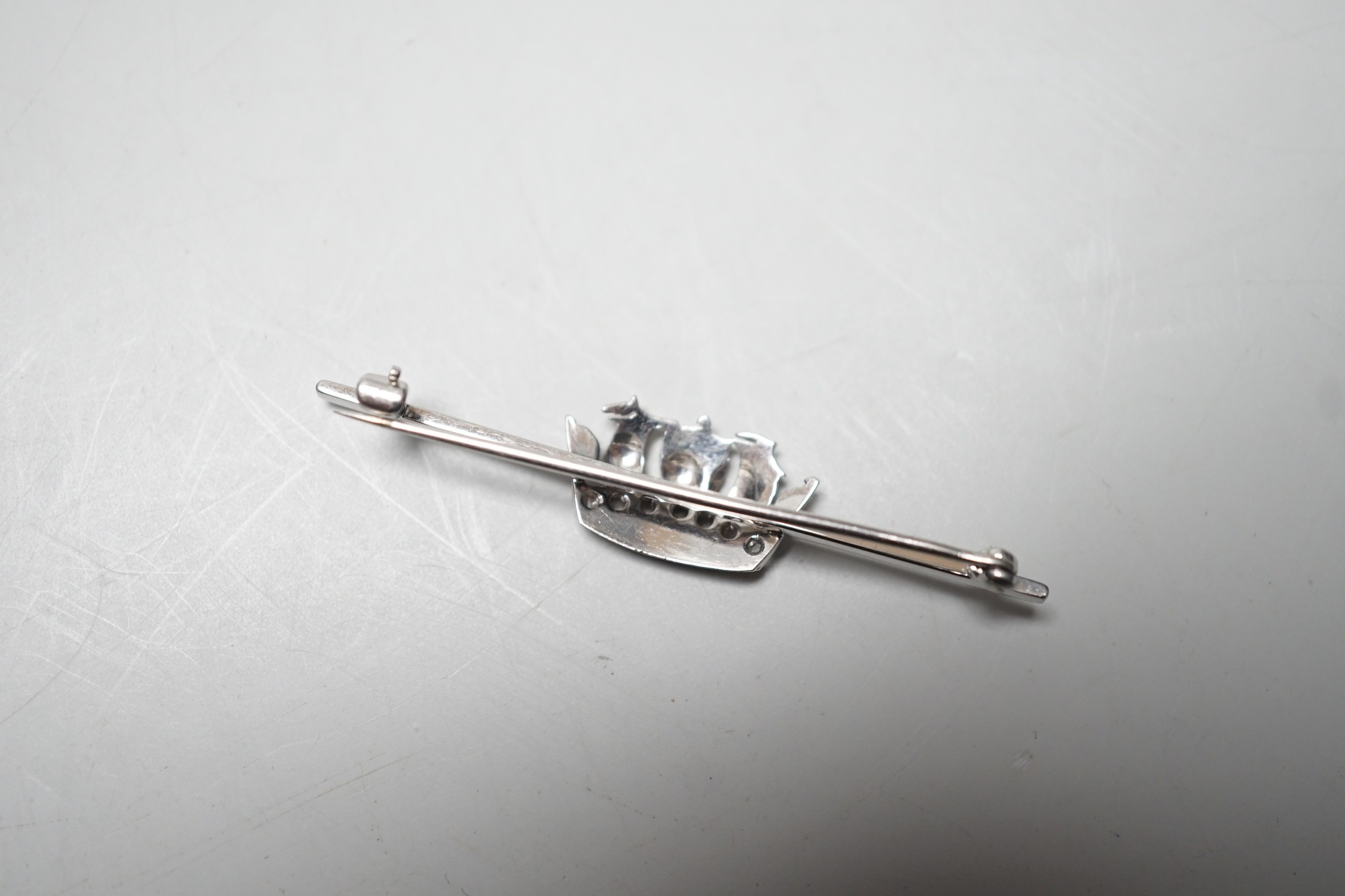 An 18ct, plat and rose cut diamond chip set coronet bar brooch, 50mm, gross weight 4.5 grams.